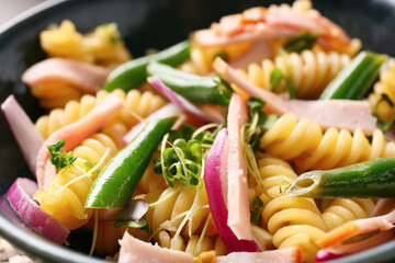 Bowl with tasty pasta salad, closeup