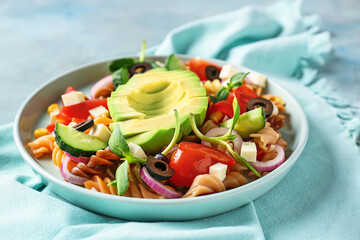 Plate with tasty pasta salad on table