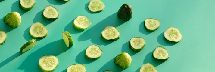 Composition with slices of cucumber on color background