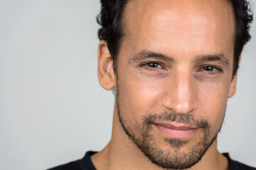 Obraz premium Portrait of handsome bearded Hispanic man with curly hair