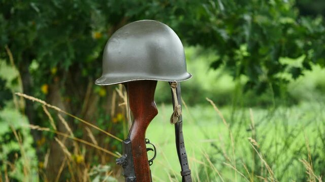 Memorial battlefield cross. Symbol of a fallen US soldier. M1 rifle with helmet.