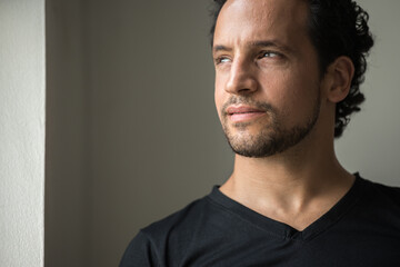 Fototapeta premium Portrait of handsome bearded Hispanic man indoors