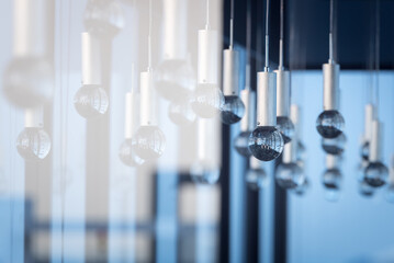 Luxury interiors of Chandelier Light pattern background at modern building.Selective focus with...