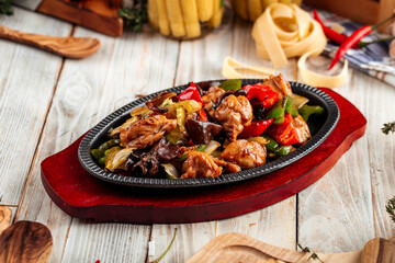 Chicken in cast-iron pan with vegetables