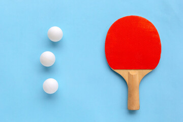 Red racket for table tennis with white balls on blue background. Ping pong sports equipment in minimal style. Flat lay, top view, copy space