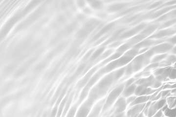 Fototapeta na wymiar Closeup of desaturated transparent clear calm water surface texture with splashes and bubbles. Trendy abstract nature background. White-grey water waves in sunlight.