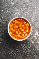 Baked beans in bowl. Beans with tomato sauce