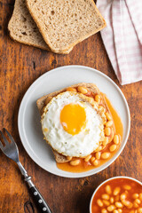 Toast with fried egg and baked beans.