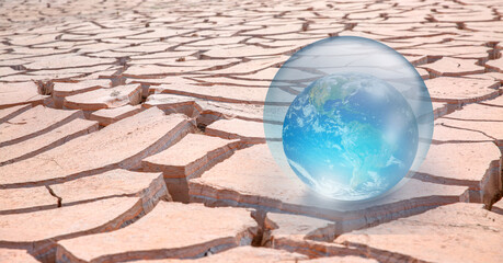 Global warming concept - Crystall ball on the sand dune with Glass Globe (Planet Earth) "Elements of this image furnished by NASA"