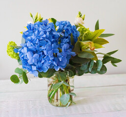 bouquet with blue hydrangea, white roses, orchids and eucalyptus