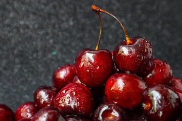 Bright juicy ripe cherry on a dark background.