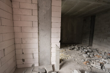 Wall smashed into debris room in apartment ready for renovation with destroyed smashed wall demolish