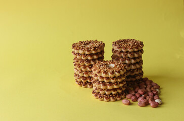 close up nuts round biscuits with peanuts on yellow background