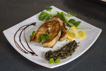 the chef chopped fresh sturgeon and grilled it