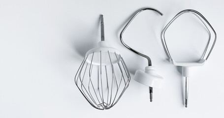 attachments for a planetary mixer, for whipping cream and kneading dough, on a white background...