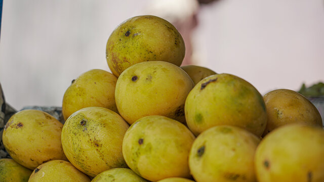 Juicy ripe mangoes on the counter in the market