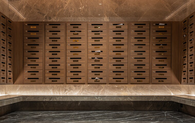 Many mail boxes made from brown wood were placed on first floor in condo. Postbox in condominium. Selective focus.