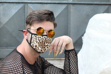Eccentric man wearing leopard camo protective face mask