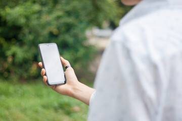 Young man looking at the phone screen