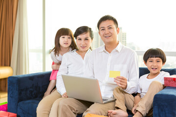 Happy family using laptop on festival day