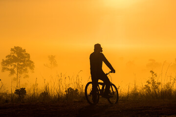 Fototapeta na wymiar Silhouette of people Cyclist look at view in the morning