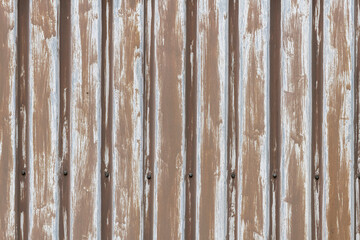 Background photo of brown metal sheet pile profiles.