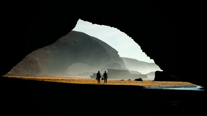 View of the Legzira beach near Sidi Ifni, Morocco, and its famous arch. Two persons can be seen under the arch for a sense of scale... © KAL'VAN