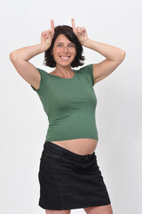 portrait of a pregnant woman with horned sign on white background
