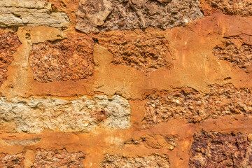 Stone texture of old ancient brick wall in sunny day. Modern luxury background for design with space for text