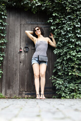 Happy woman posing at green nature background outdoor in summertime 