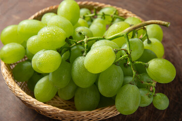 bunch of grapes on a wooden table