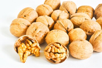 Walnuts scatter isolated on a white background. Healthy food concept. with copy space, close-up.