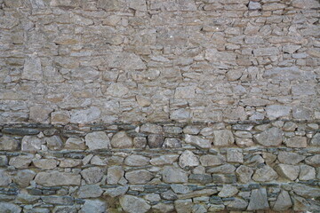 Close up of stone wall with cement. Texture of stonewall. Stones wall background.