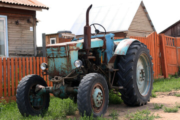 Baikal / Russia - June 29 2019: closeup shot of a blue vintage tractor, Farm / Agricultural Vehicle. Photo with copy space