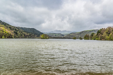 Beautiful picturesque volcanic lake in Volcans d'Auvergne regional natural park. Monts Dore Mountains, Auvergne, France.