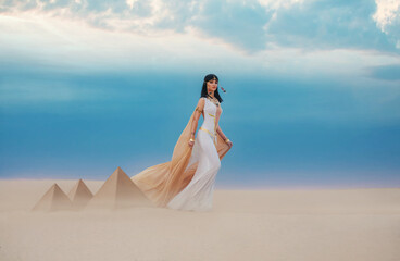  young beautiful woman model image Queen Cleopatra walks in desert Egyptian pyramids. Creative...