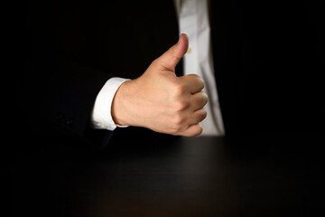 businessman making the OK gesture with his hand