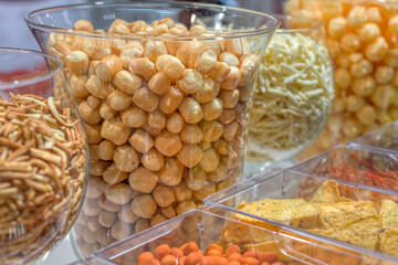 A variety of cheese balls on a store window.