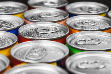 aluminum cans with carbonated water, energy drinks or beer. Background of aluminum cans