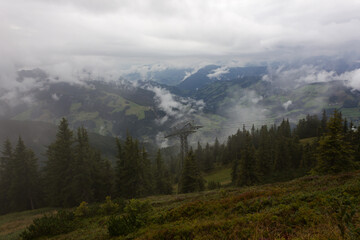Alpine mountain landscape with rainy clouds