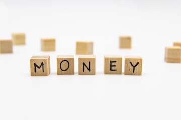 A word Money written on the wood cubes. Money lettering made of wooden cubes isolated on white