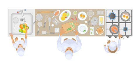 Cooks in the kitchen are cooking. Top view.