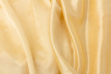 Obraz premium Smooth elegant golden silk or satin luxury cloth texture can use as wedding background. Luxurious background design. Retro style