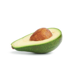 half ripe green avocado with a brown pit isolated on a white background