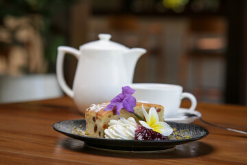 Raisin bread decorated with edible flowers served on the wooden table