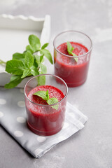 Fresh strawberry mousse dessert with mint leaves in two glasses