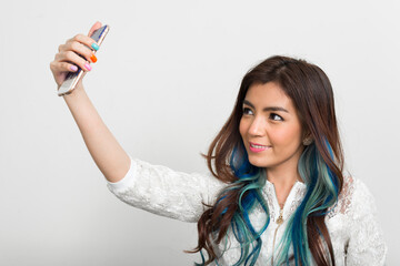 Portrait of young beautiful Asian woman with dyed hair