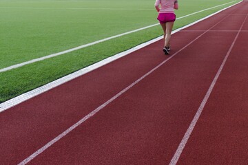 Fototapeta premium woman on treadmill running view from the back