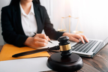 Business and lawyers discussing contract papers with brass scale on desk in office. Law, legal services, advice, justice and law concept picture with film grain effect