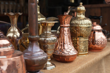 Fototapeta na wymiar Assortment of stylized Oriental copper dishware